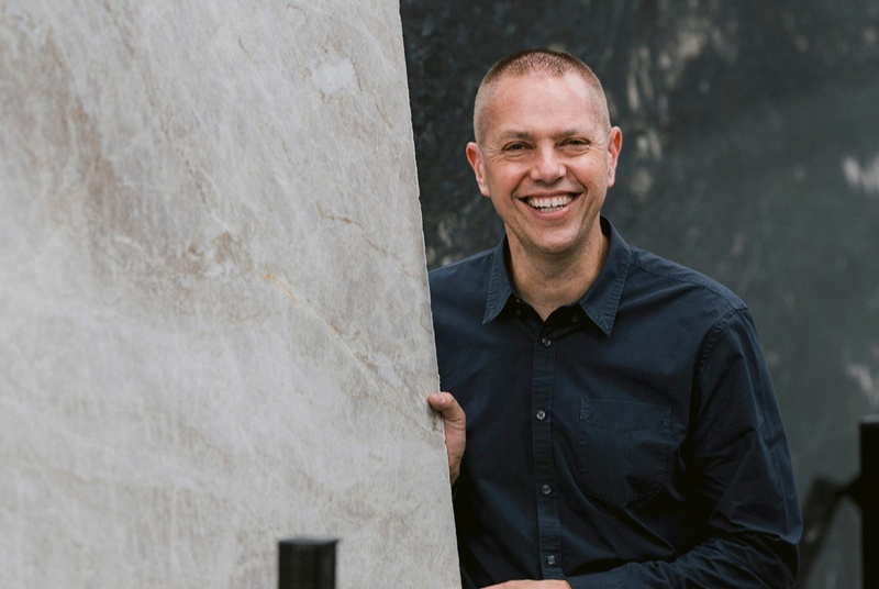 Nathan from CAV’ART leaning on a stone slab