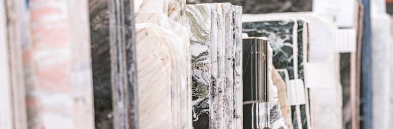Natural stone slabs stacked on their edges in the CAV’ART warehouse